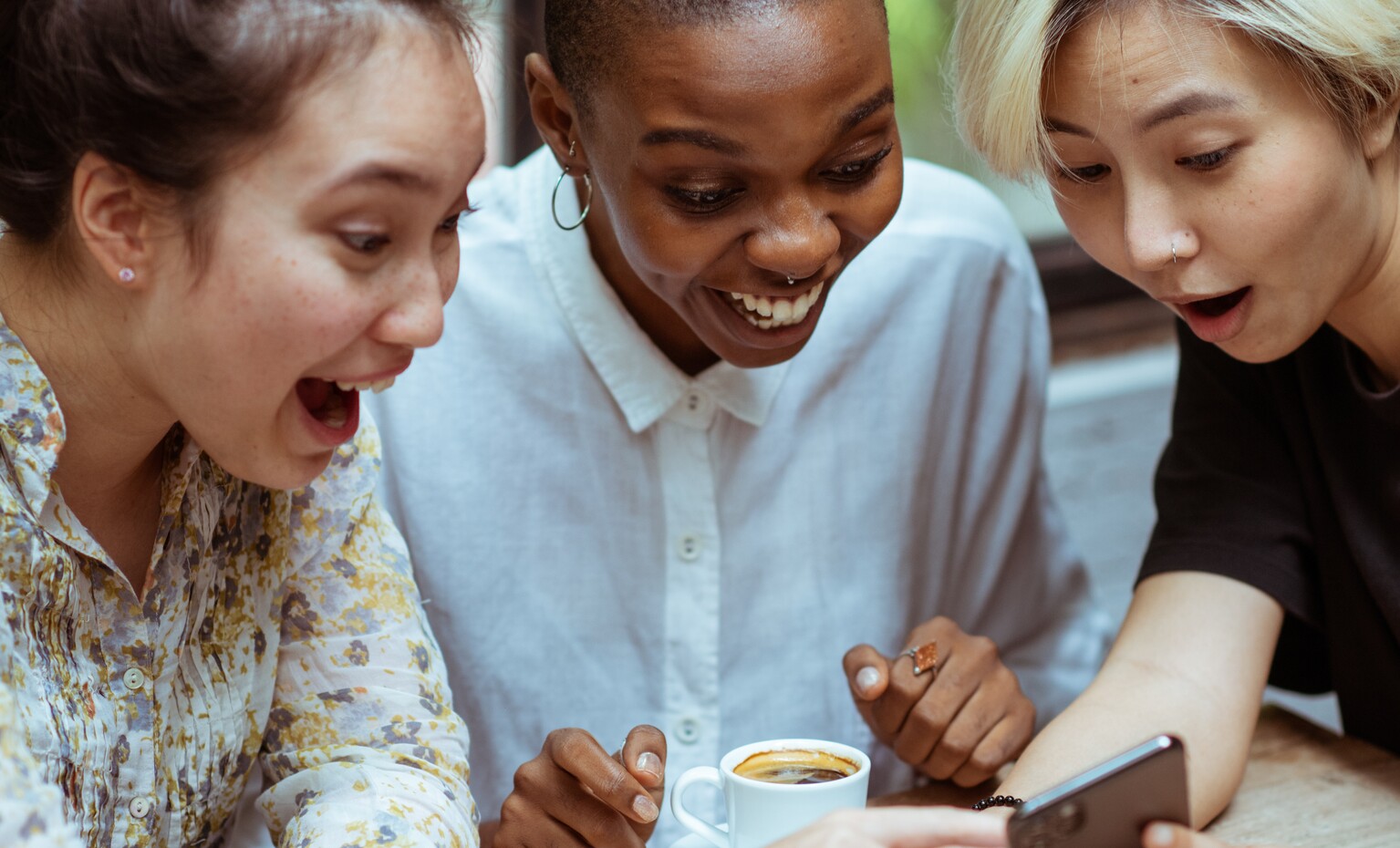 Girls get excited while watching to a mobile phone